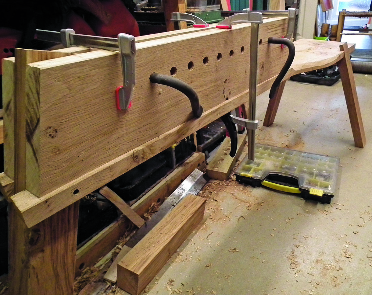 The side boards being clamped in place and tested for screwing together.