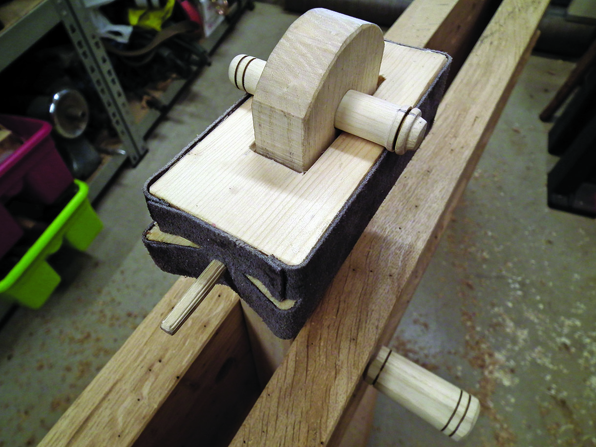 The clamping head mounted in the final position on the shave horse. The tenon from the swing arm is fully through and held with a turned pin.