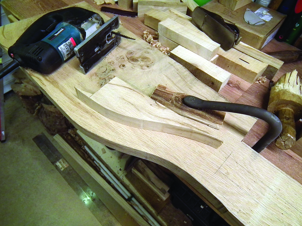 The curves of the seat after one side has been cut. An electric jig saw is being used to make curved cuts.