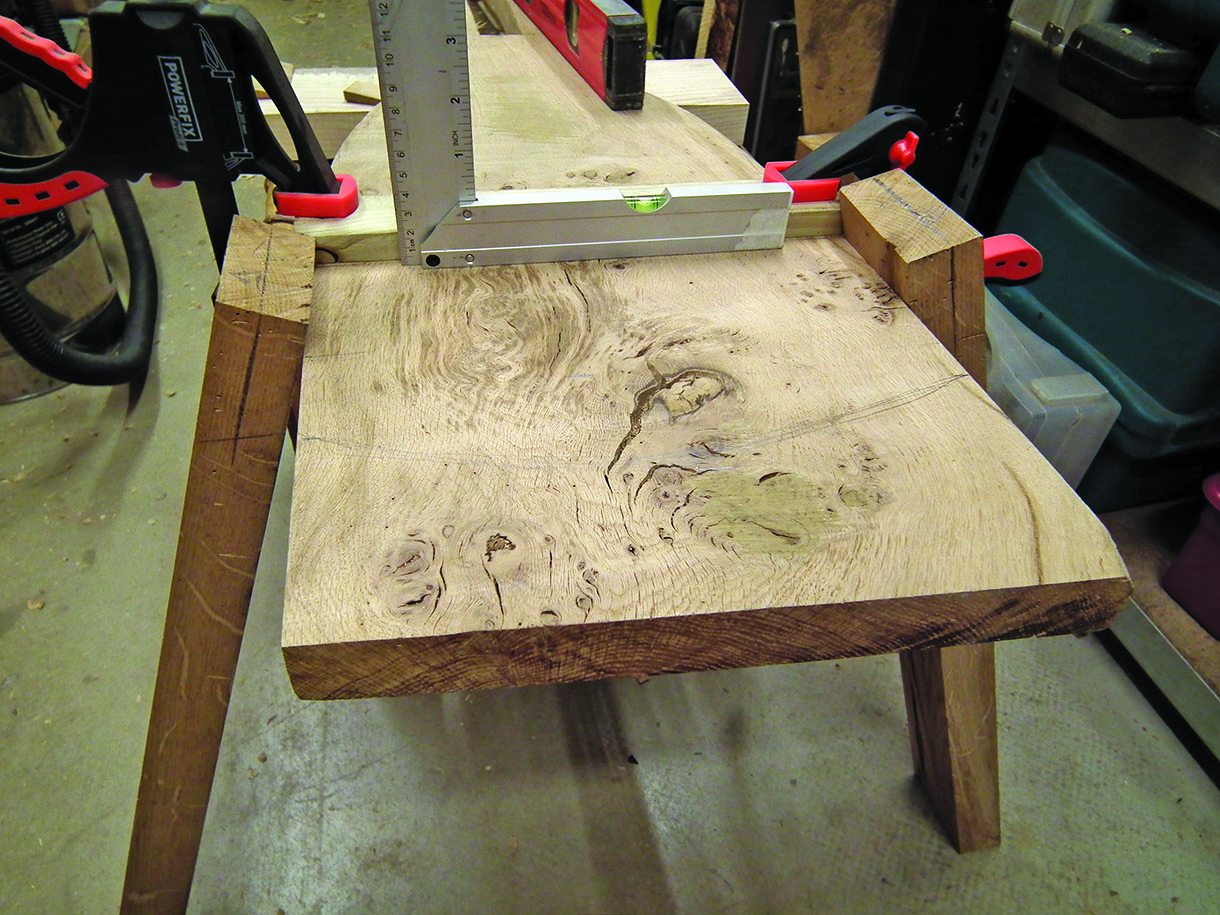 The rear legs being offered up to test the angles and mark up the cuts.
