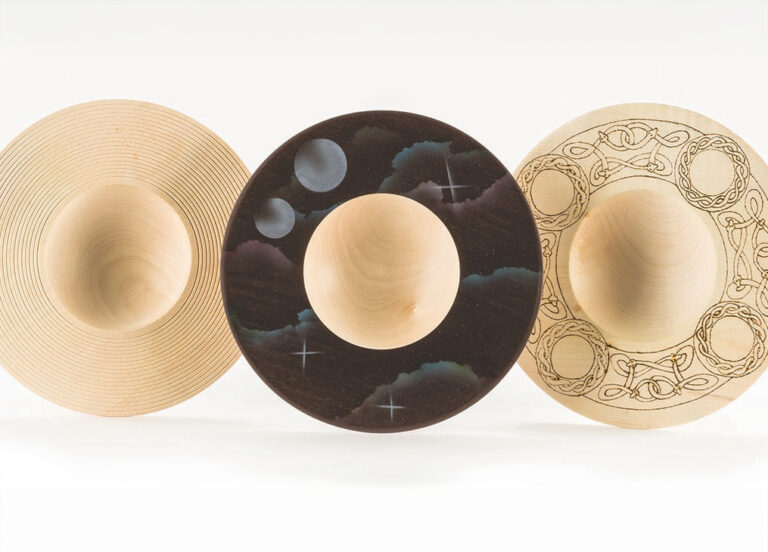 Three decorative wooden bowls with unique designs.