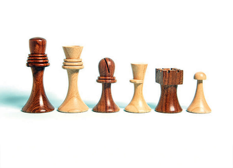 Unique wooden chess pieces on white background.