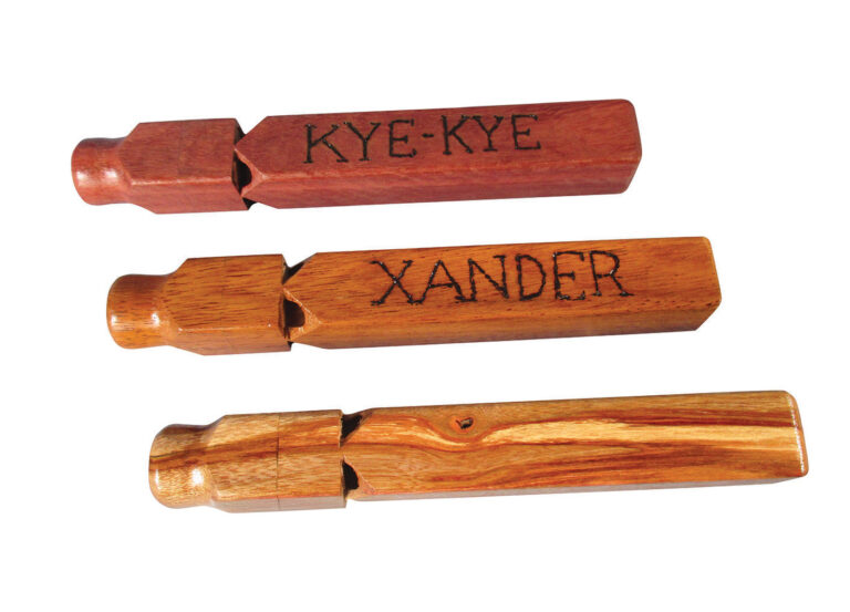 Three engraved wooden train whistles