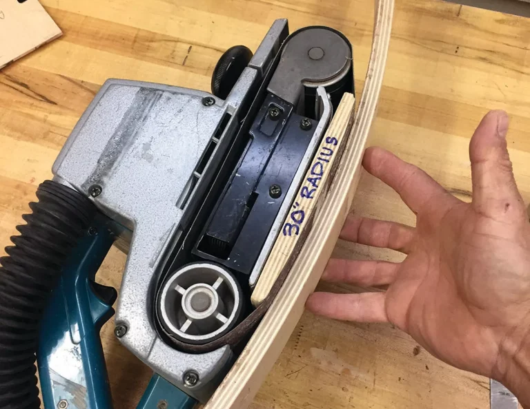 Belt sander on curved wooden surface with 30" radius.
