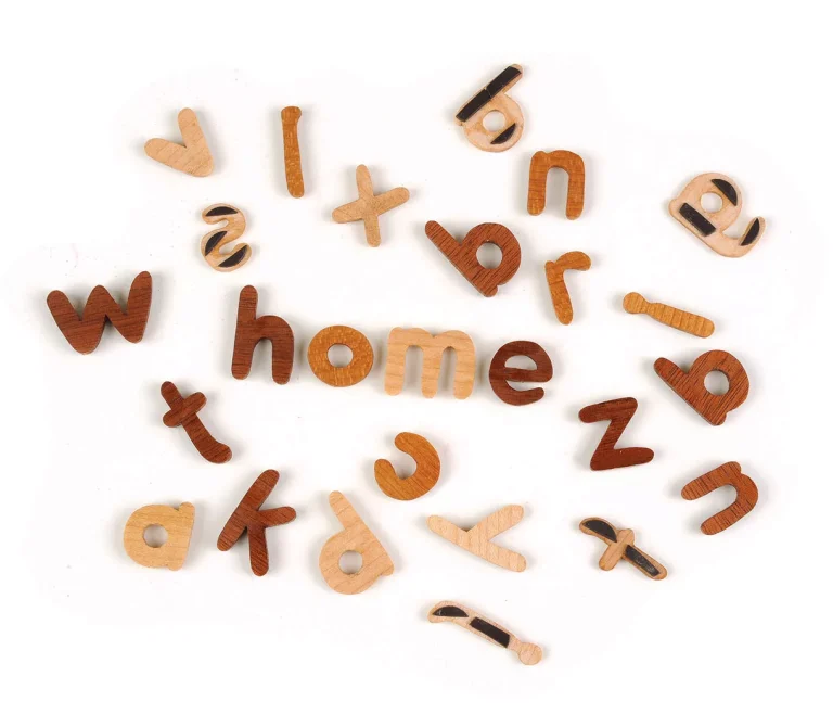Wooden letters spelling "home" on a white background.