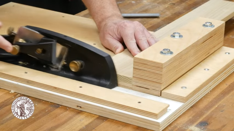 Woodworker using bench plane on wood jig.