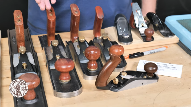 Various hand planes on woodworking bench.