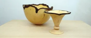 Handcrafted wooden bowls with artistic edges on display.
