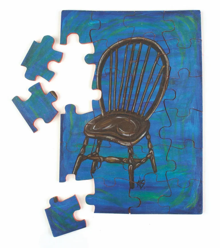 Incomplete puzzle with chair art on blue background.