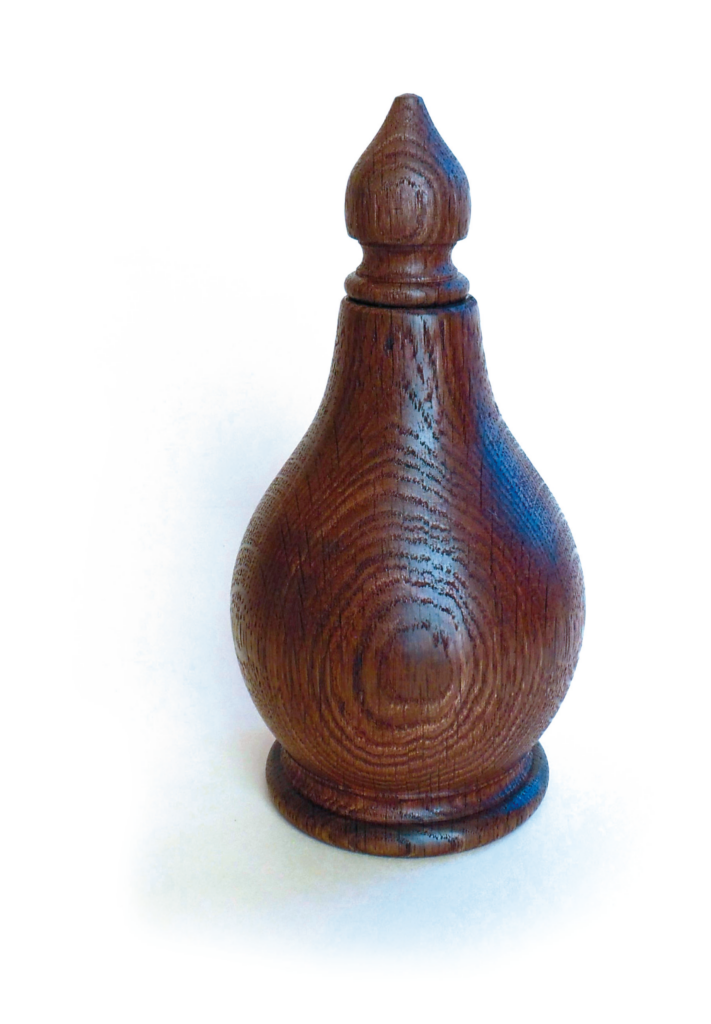 Wooden turned vase with intricate design.