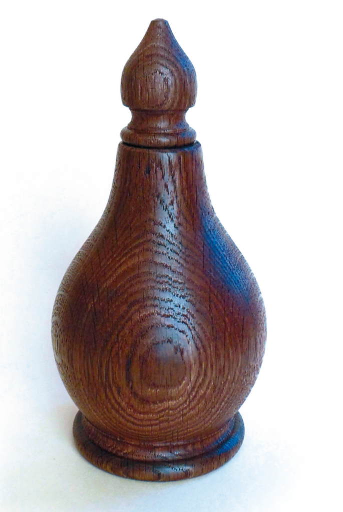 Wooden turned vase with intricate design.