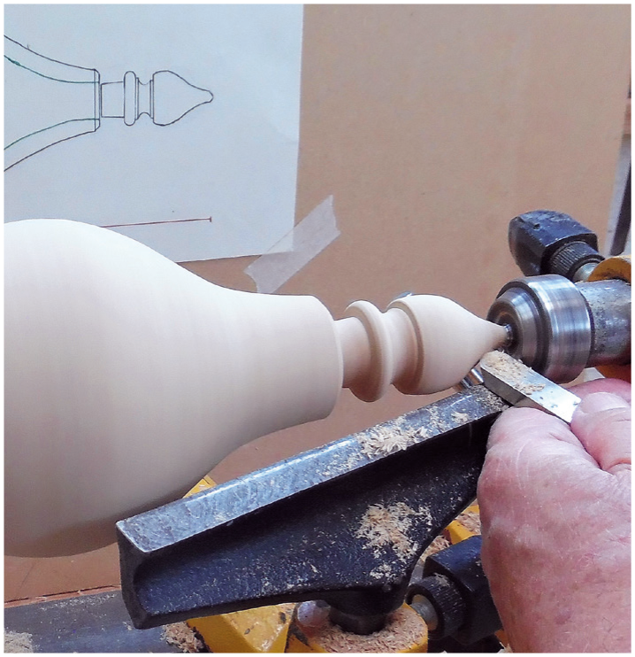 Woodturning a spindle on a lathe machine.