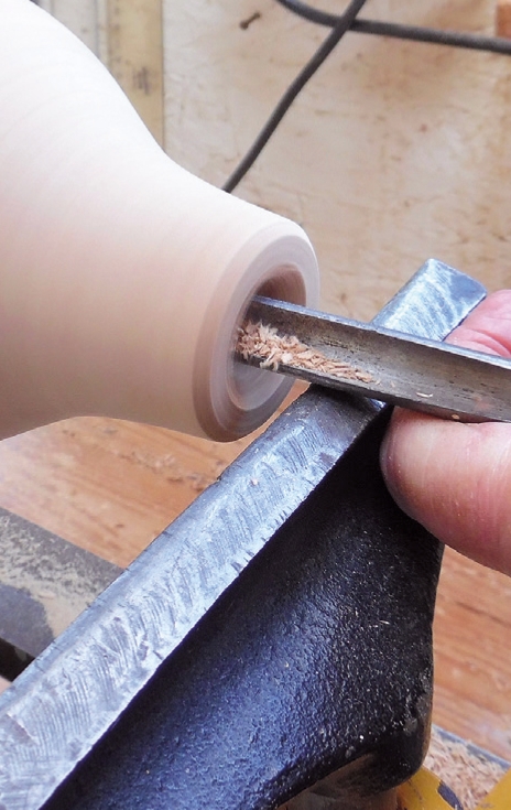 Woodturning a wooden spindle on a lathe.