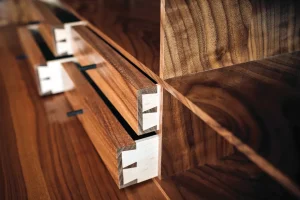 Close-up of dovetail joint on wooden furniture.