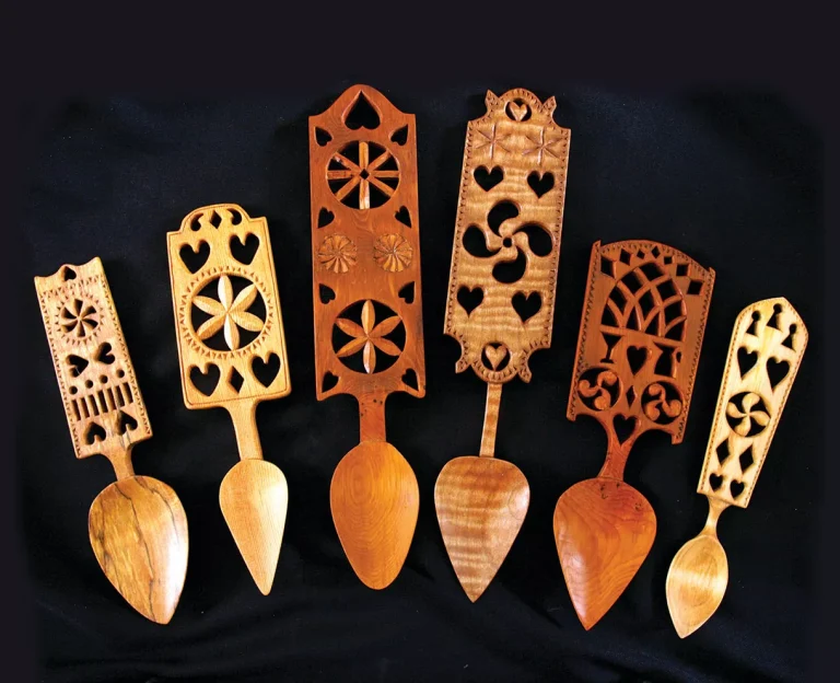Hand-carved wooden spoons with intricate designs on display.