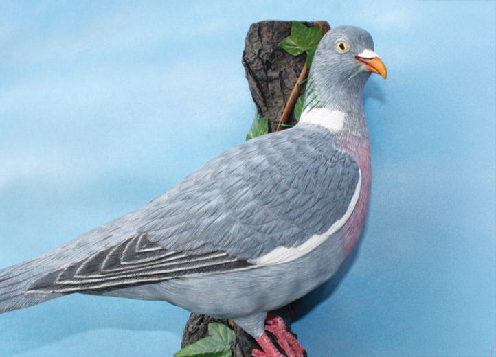 Realistic pigeon cake sculpture on blue background