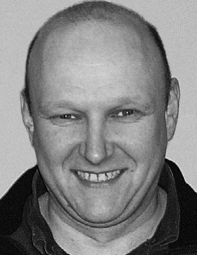 Smiling person in black and white portrait.