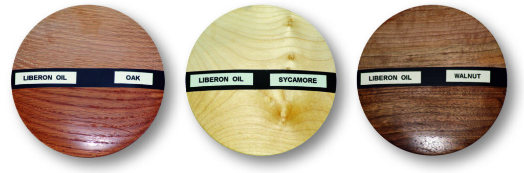 Three wood samples with Liberon oil labels.