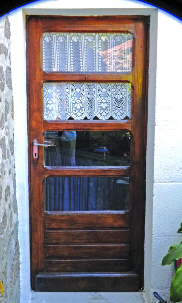 Wooden door with lace curtain panels