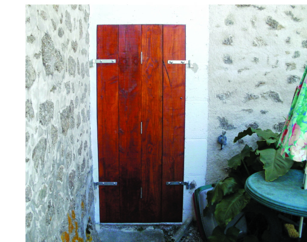 Wooden door in stone wall passage