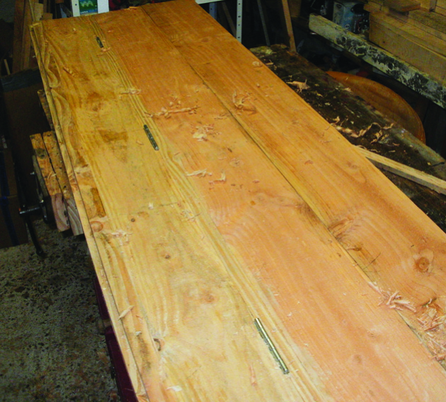 Wooden table top under construction in workshop.