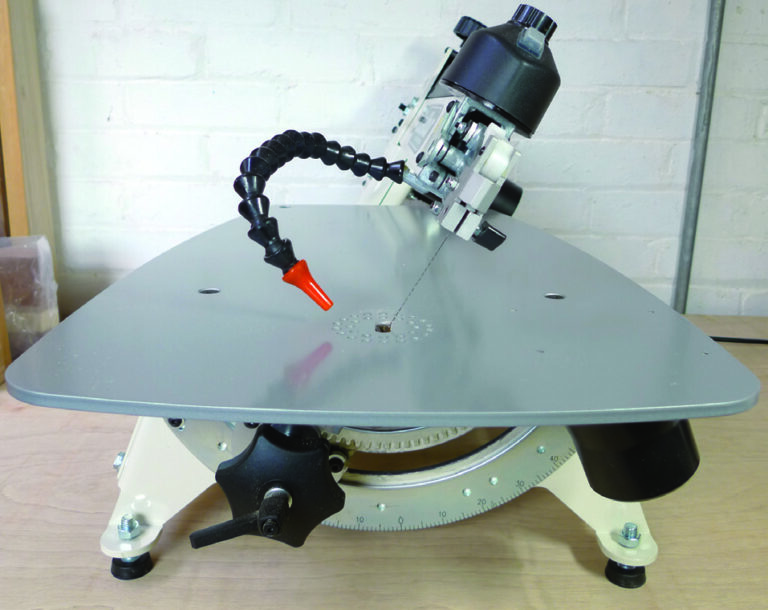 Scroll saw on tabletop with adjustable arm