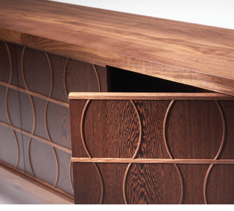 Wooden cabinet with geometric pattern design.