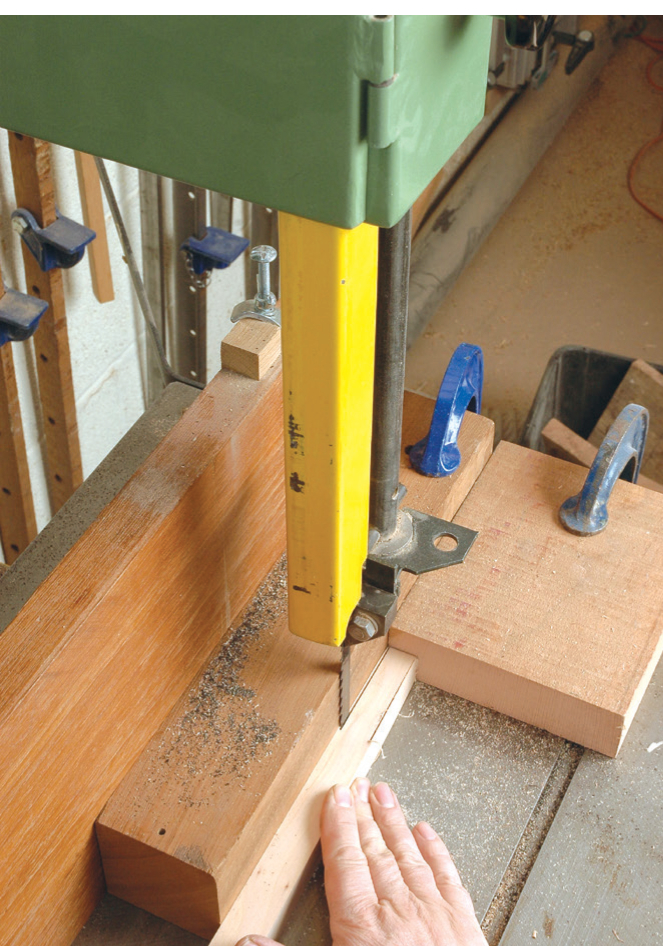 Band saw cutting through a wooden plank