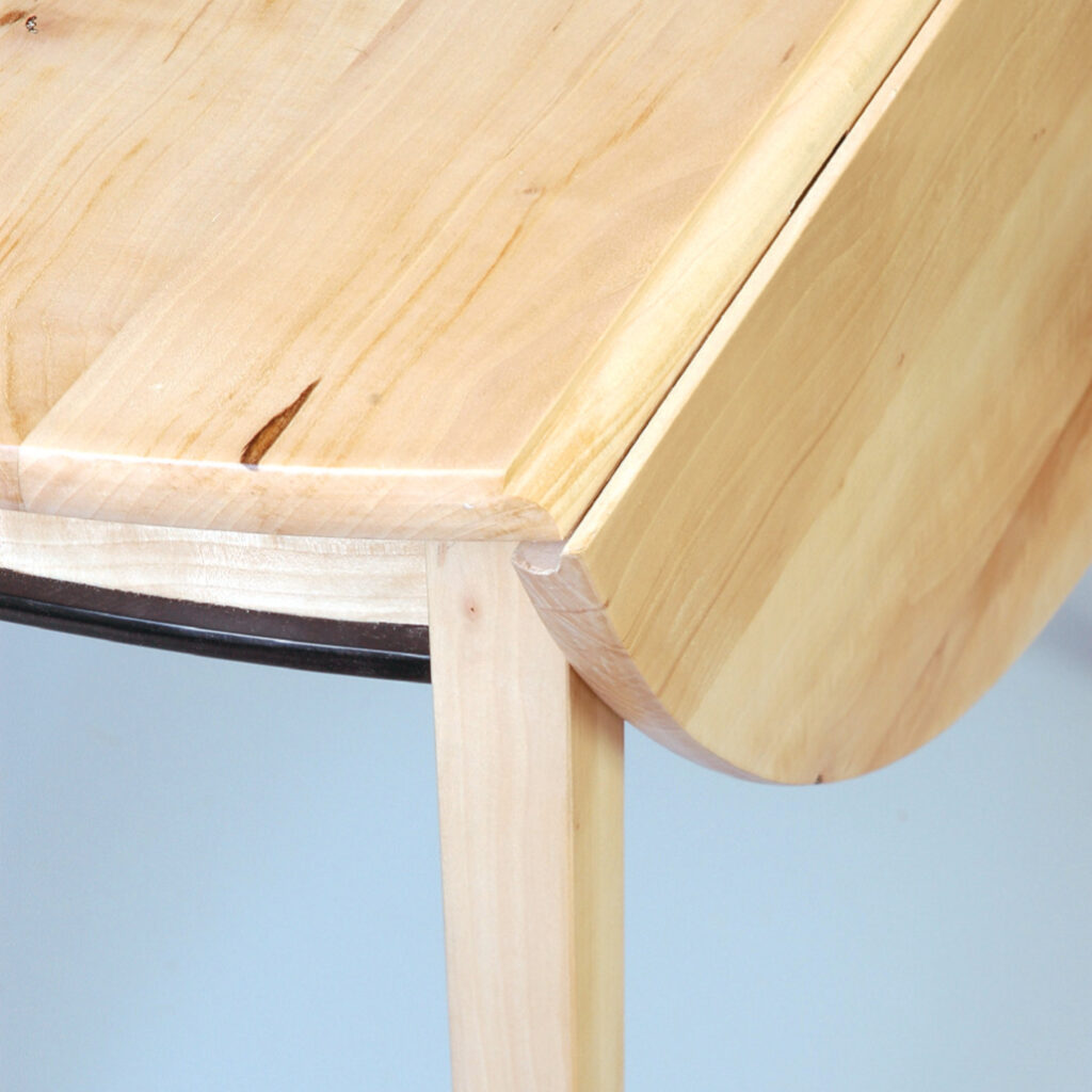 Wooden drop-leaf table corner detail