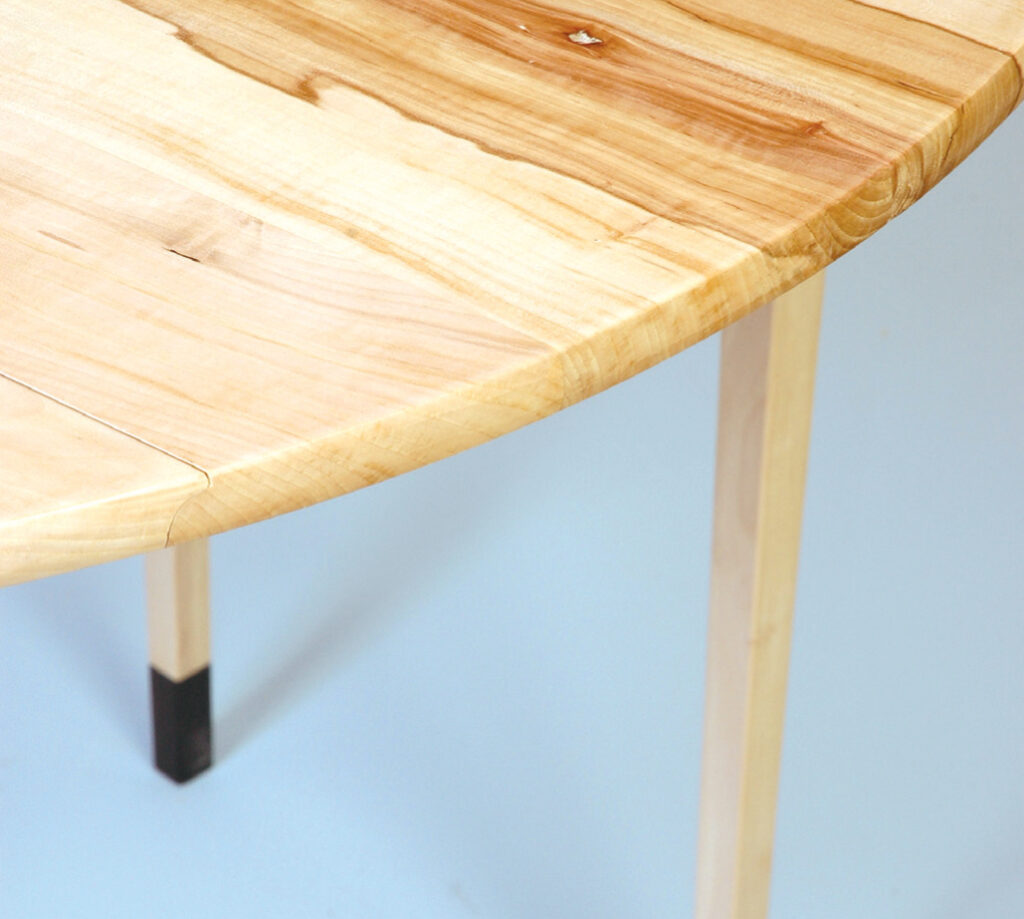 Round wooden table with natural finish