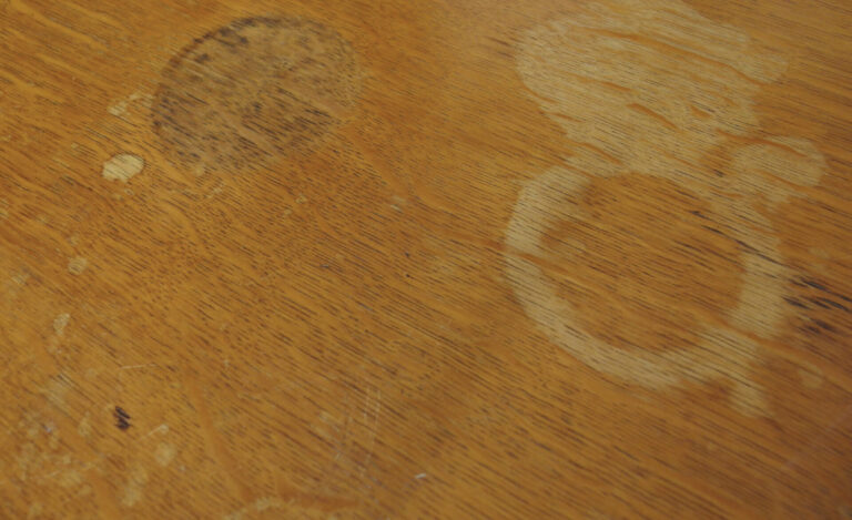 Wooden surface with visible white cup stains.