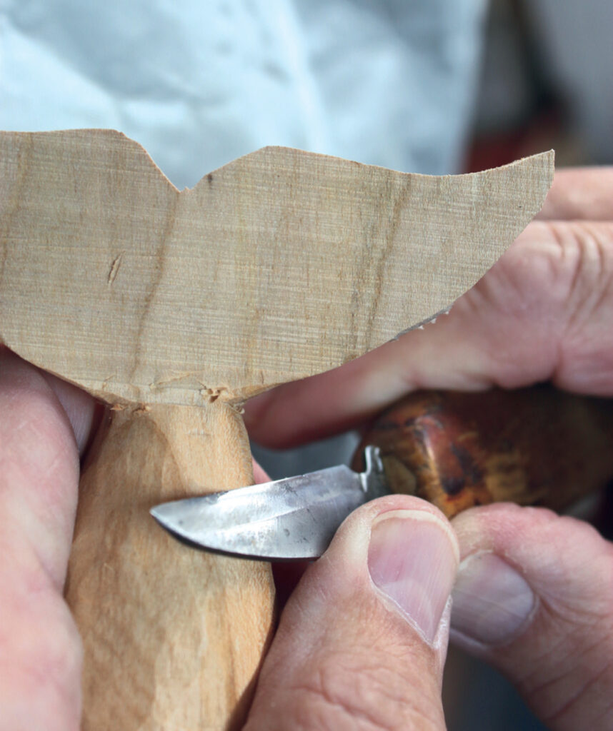Wood carving with a knife close-up