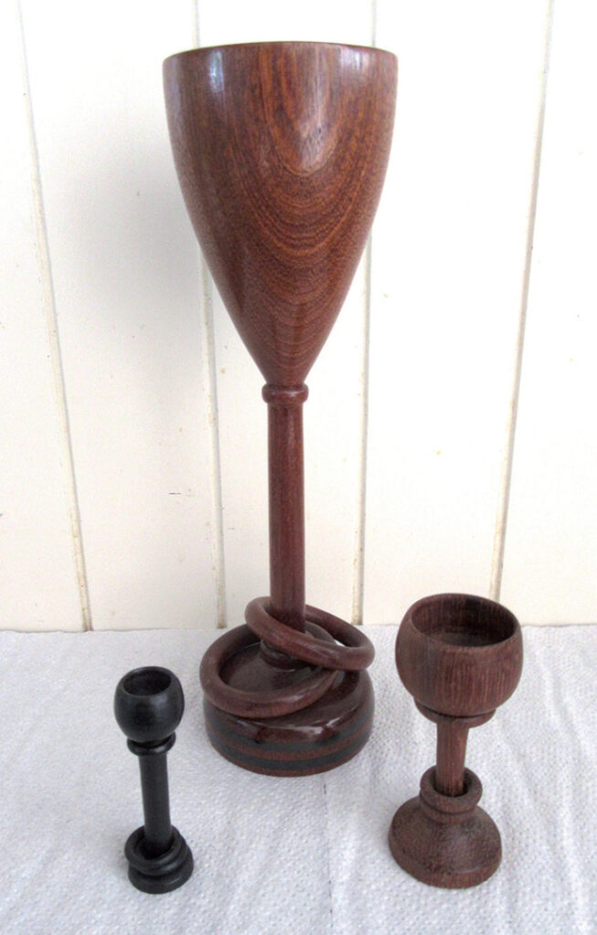 Wooden goblets and stand on white surface