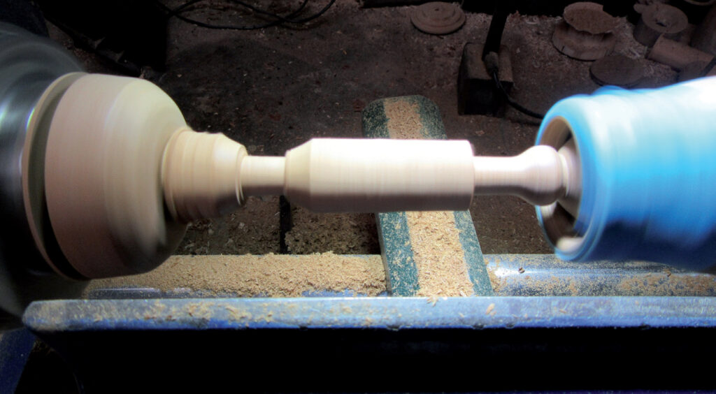 Woodworking lathe shaping wooden spindle