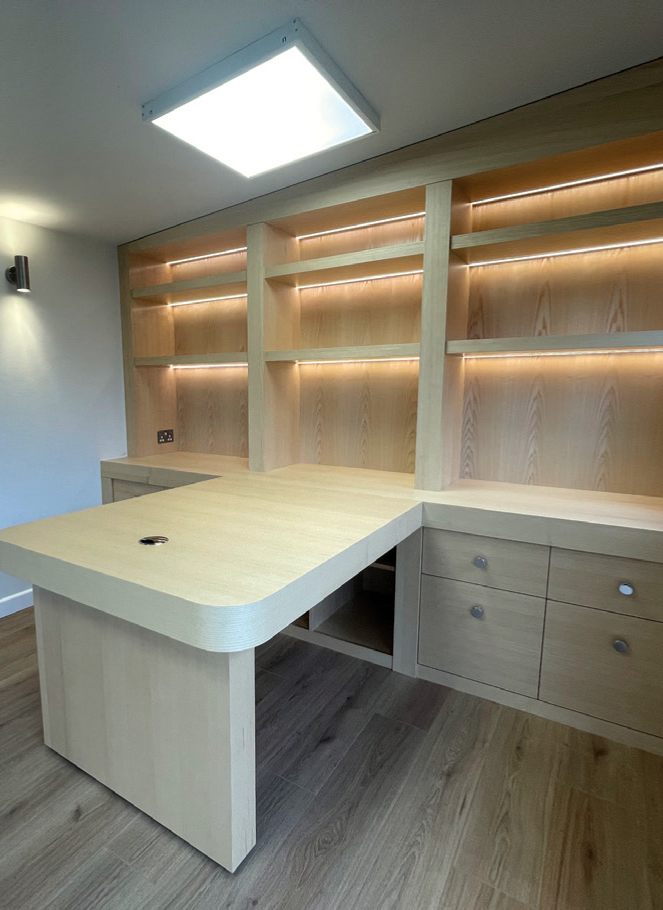 Modern wooden desk with built-in shelves and drawers.
