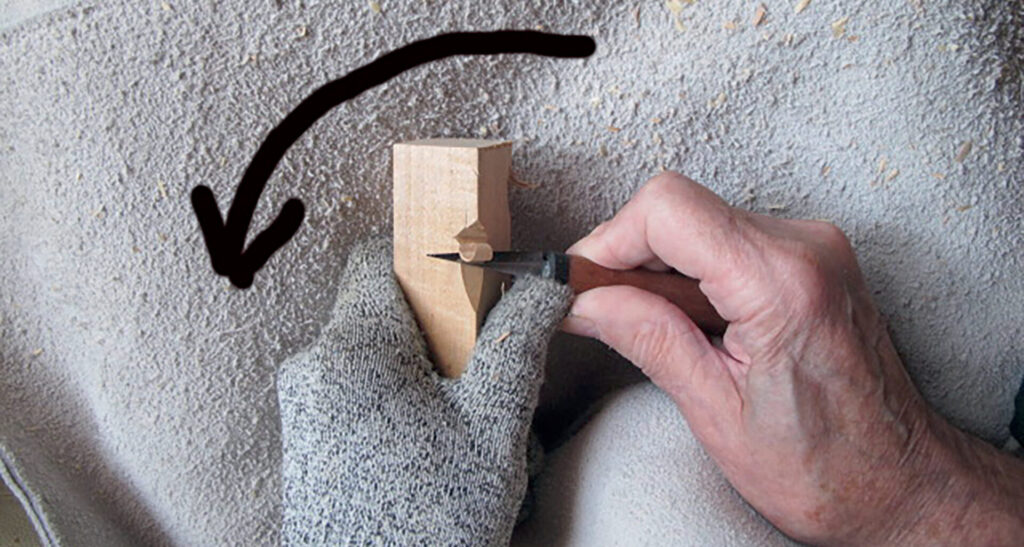 Hand carving wood with precision tools.