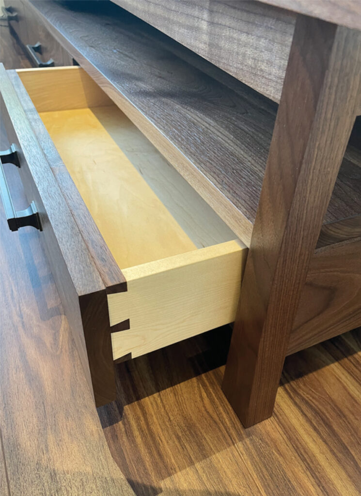 Open wooden drawer on hardwood floor