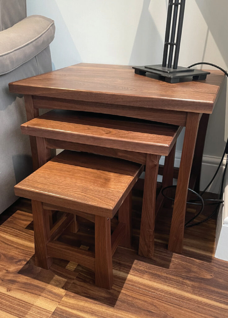 Wooden nested tables near grey sofa