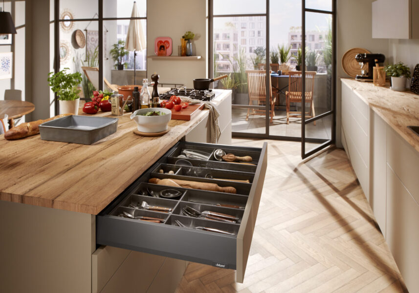 Modern kitchen with open drawer and patio view.
