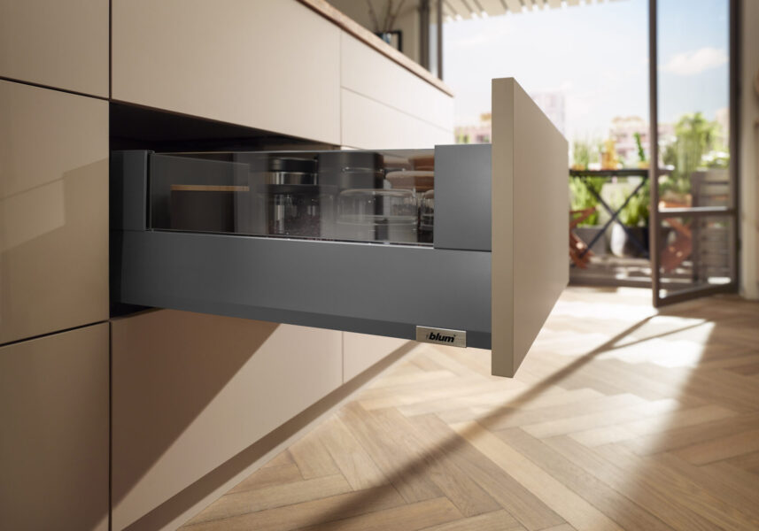 Modern kitchen drawer with glass sides pulled out.