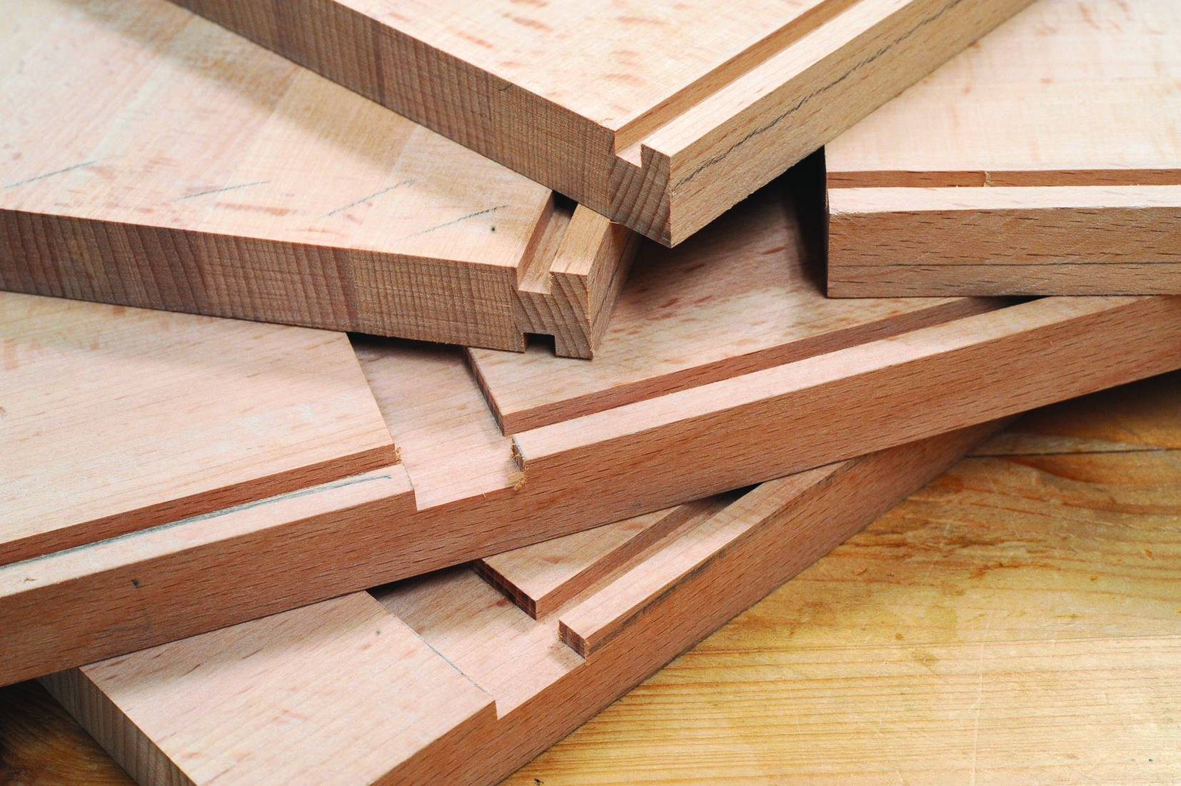 Stack of grooved wooden planks on table.