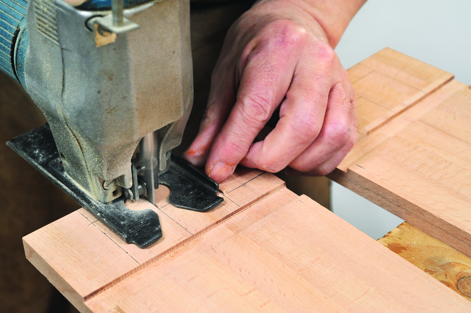 Carpenter using jigsaw to cut wood