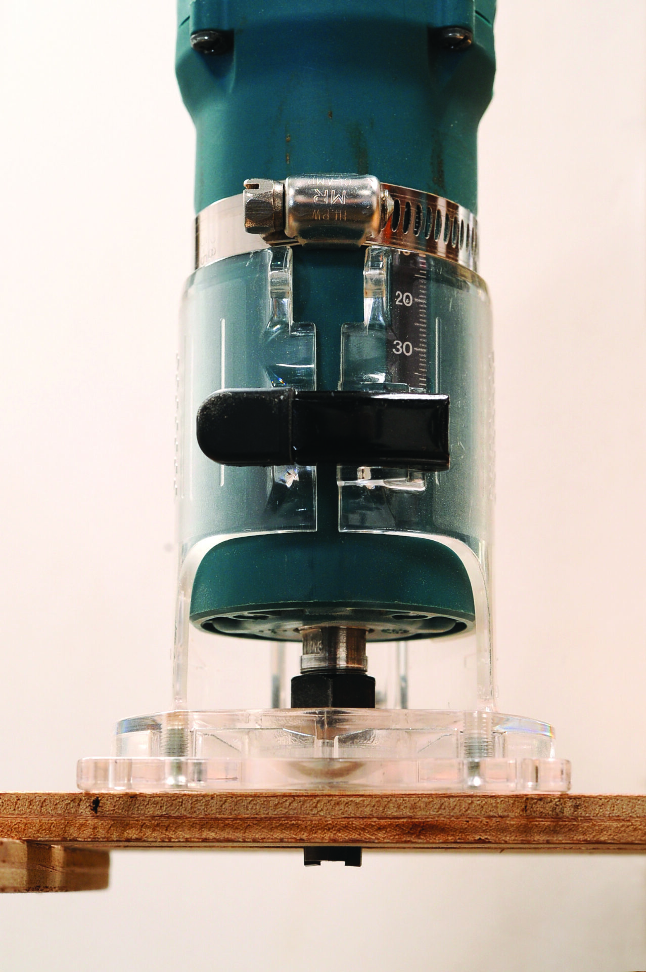 Electric wood router on wooden surface.