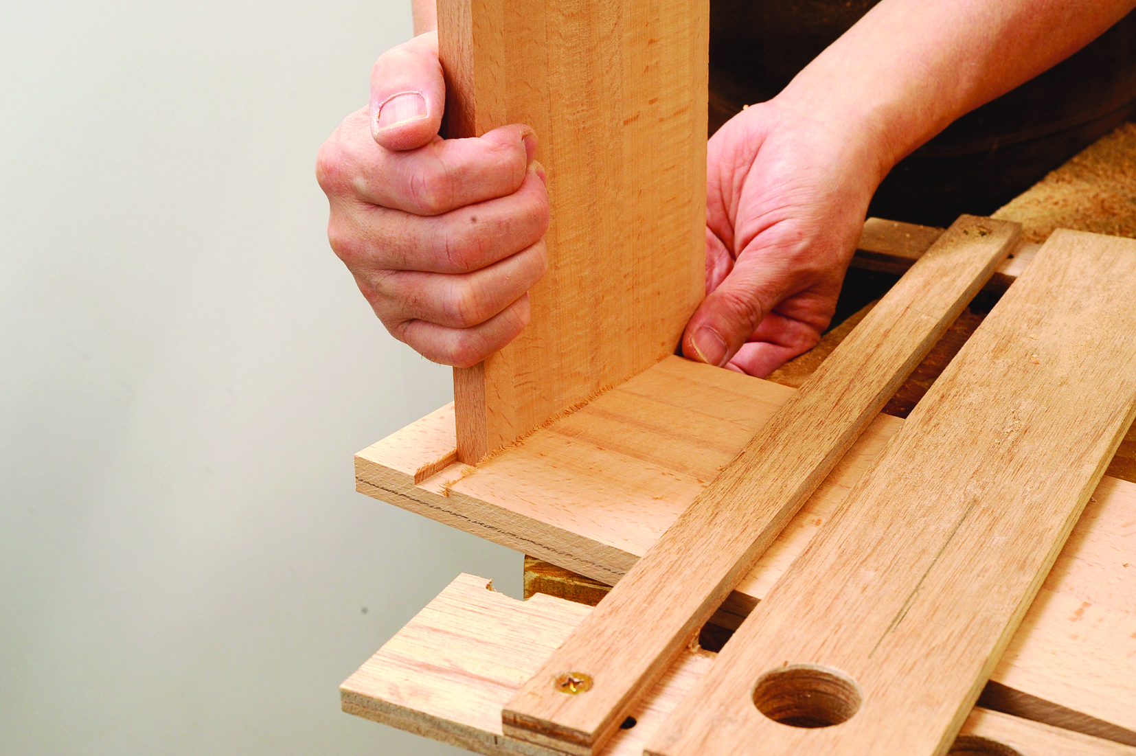 Hands assembling wooden joinery piece