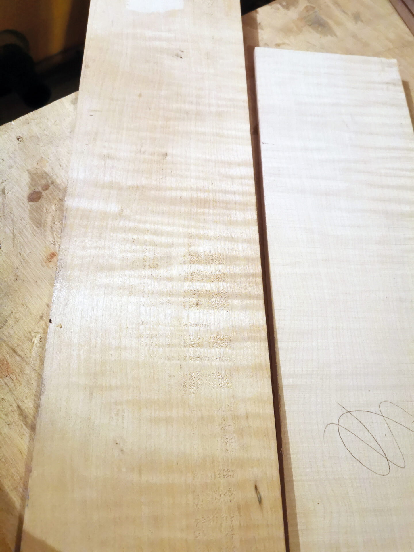 Two light wooden boards on a table.