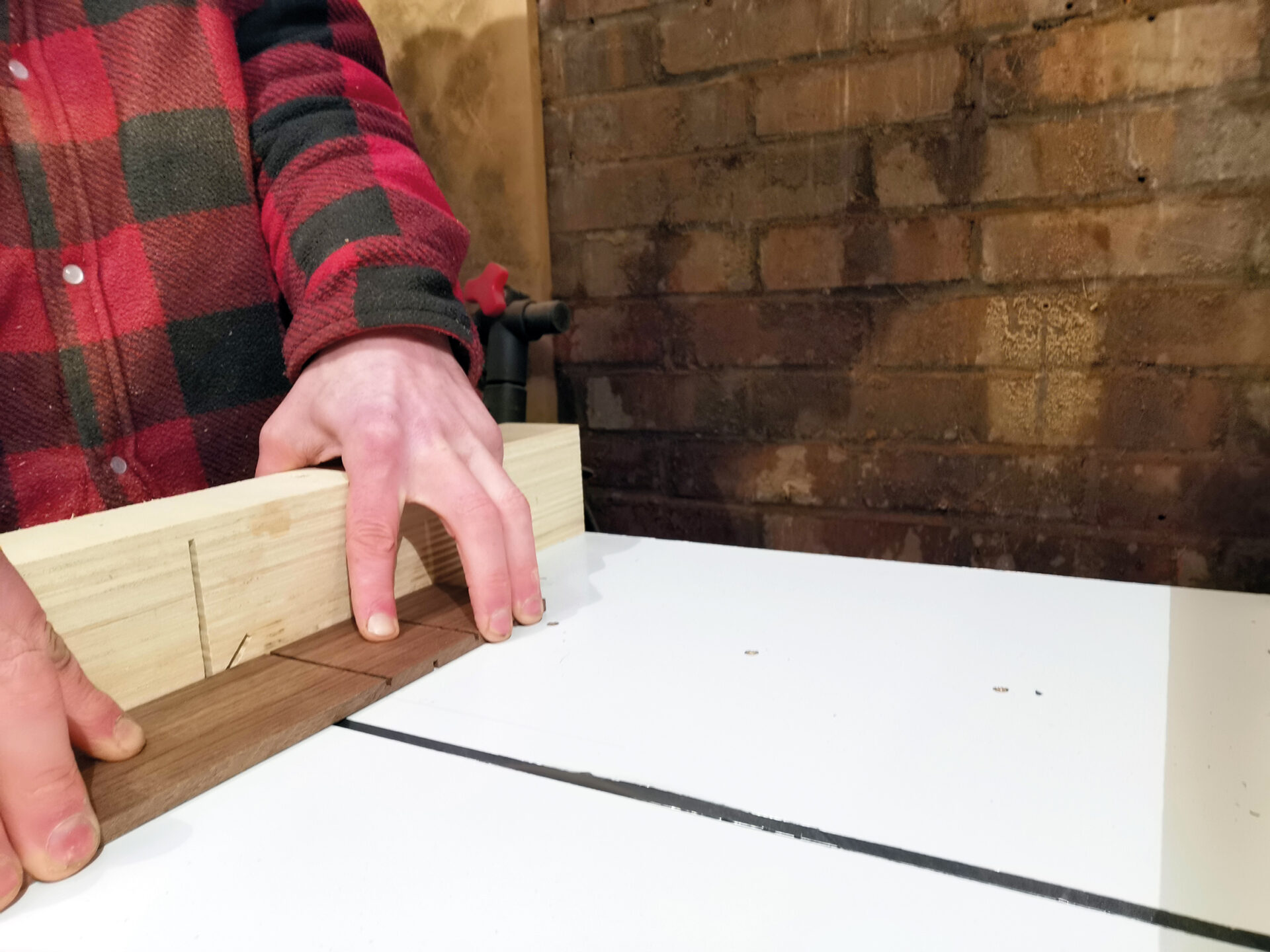 Person making precise wood cut on table saw.