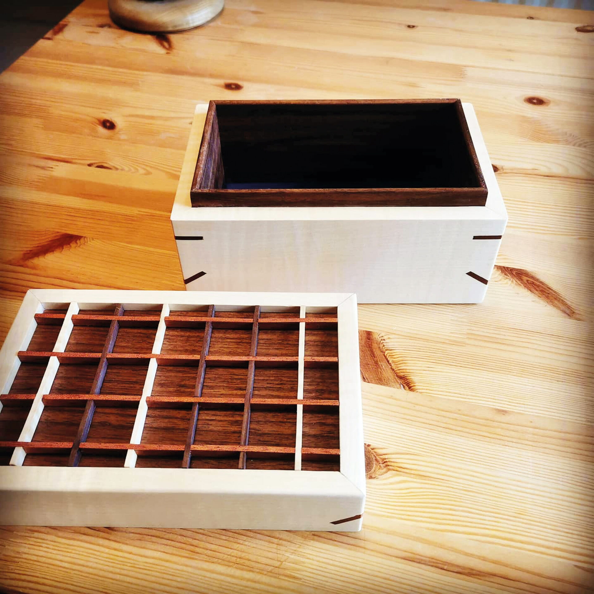 Handmade wooden box with lattice lid on table.