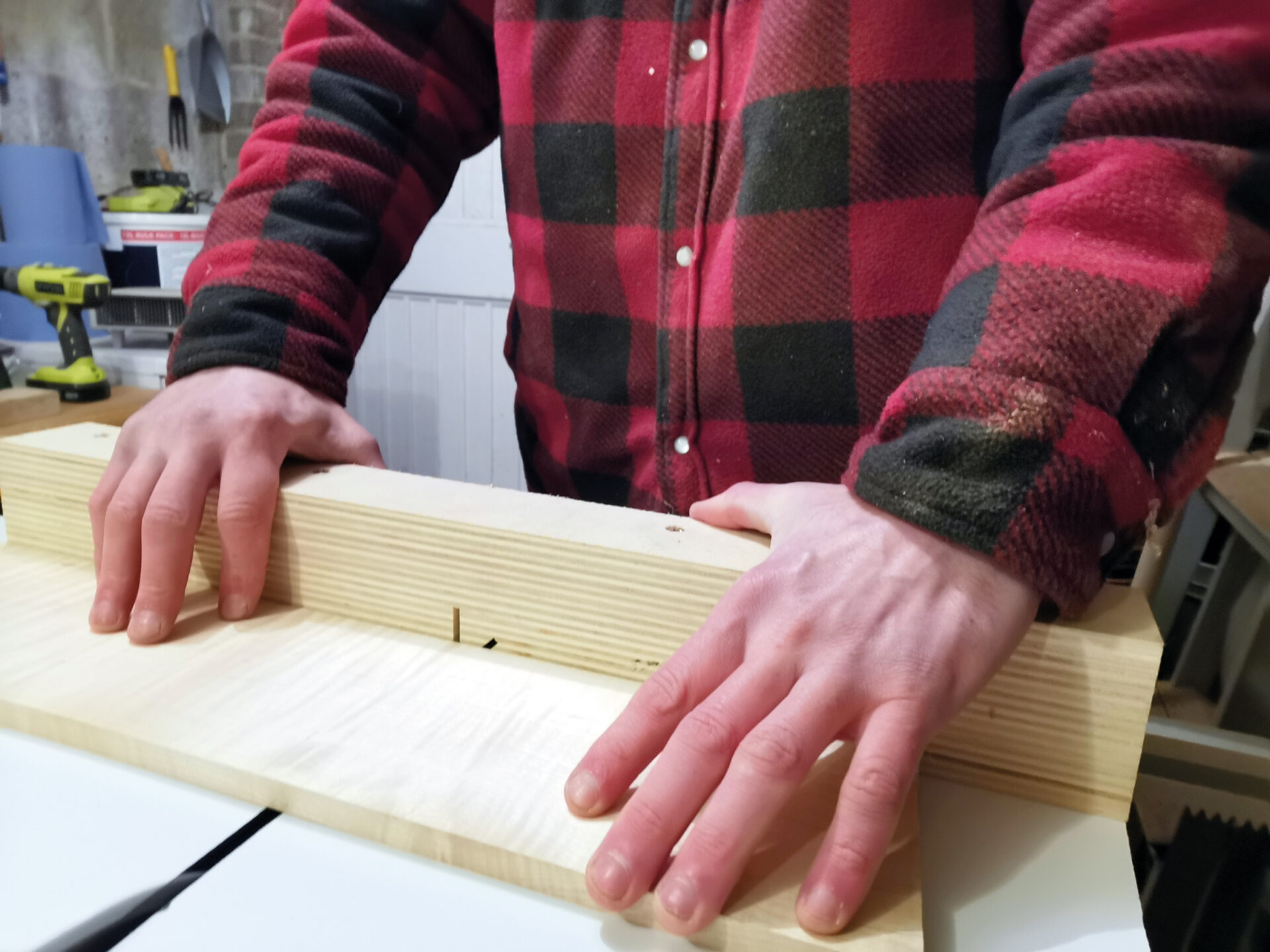 Person using jig to cut wood precisely.