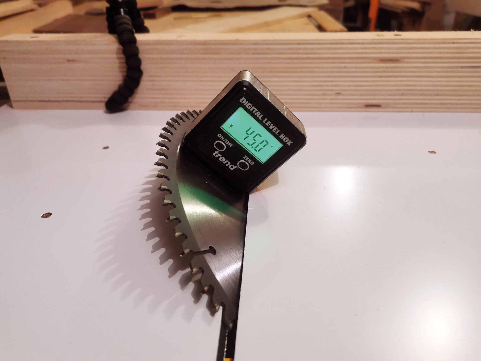 Digital level on saw blade at 45 degrees.
