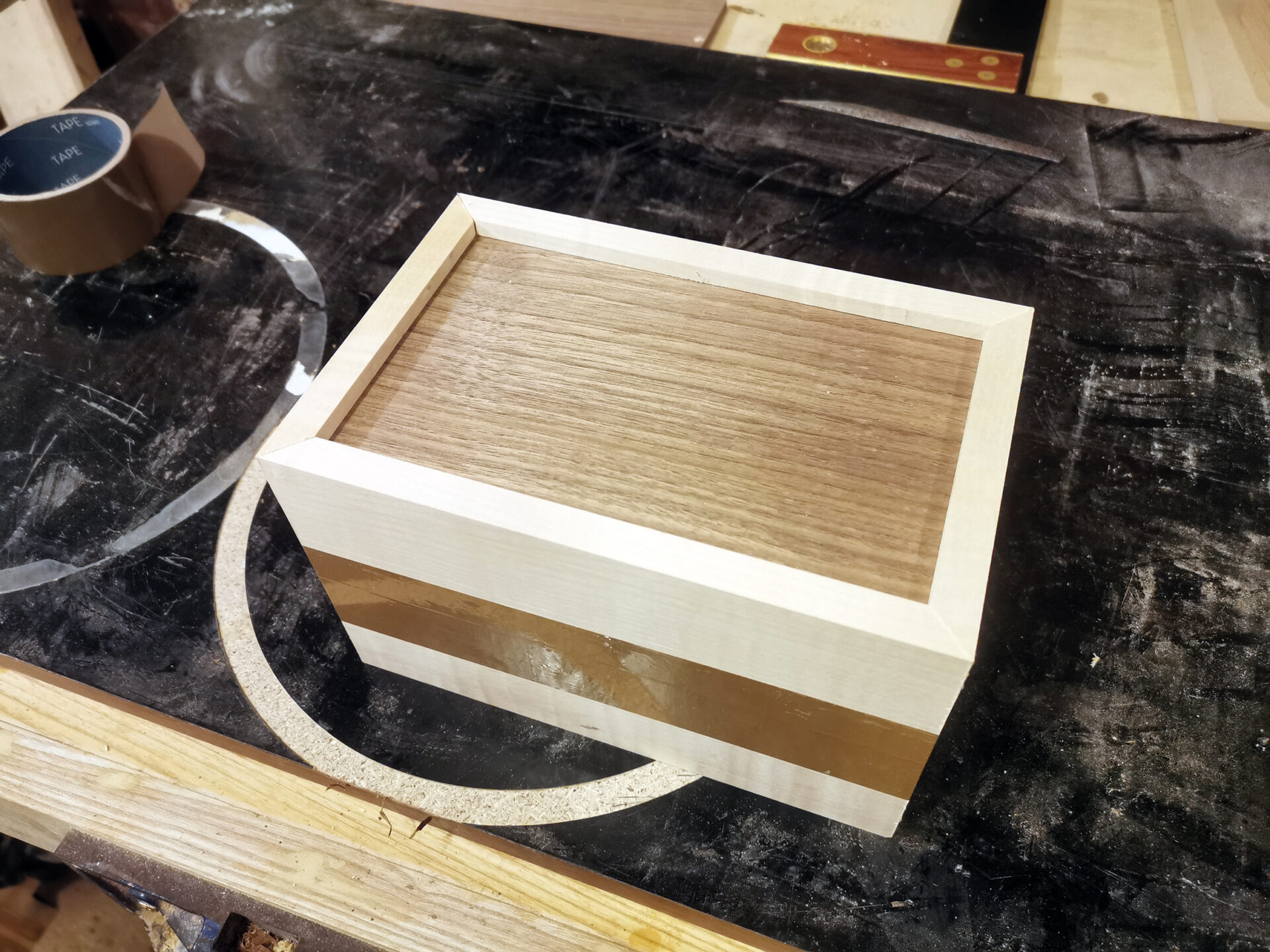 Handcrafted wooden box on a workbench.